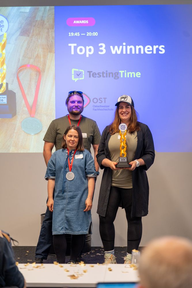 Top 3 winners on stage with trophy